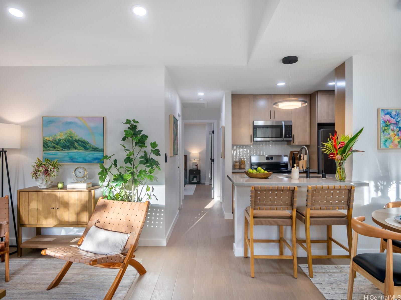 95-664 Wikao Street, Unit L205 Mililani, HI 96789 - Photo 3 of 25 a living room with furniture a dining table and kitchen view