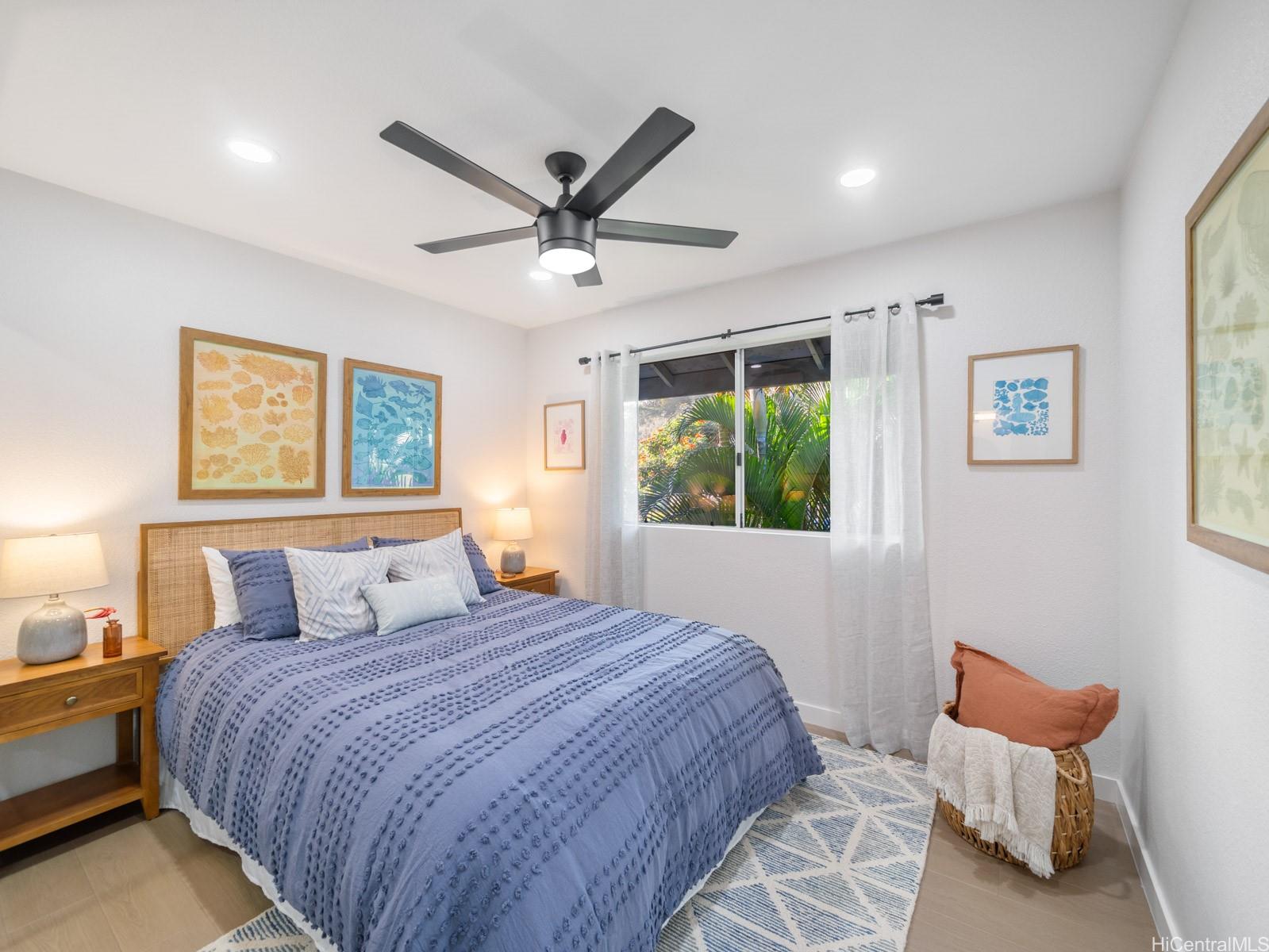 95-664 Wikao Street, Unit L205 Mililani, HI 96789 - Photo 9 of 25 a bedroom with a large bed and a window