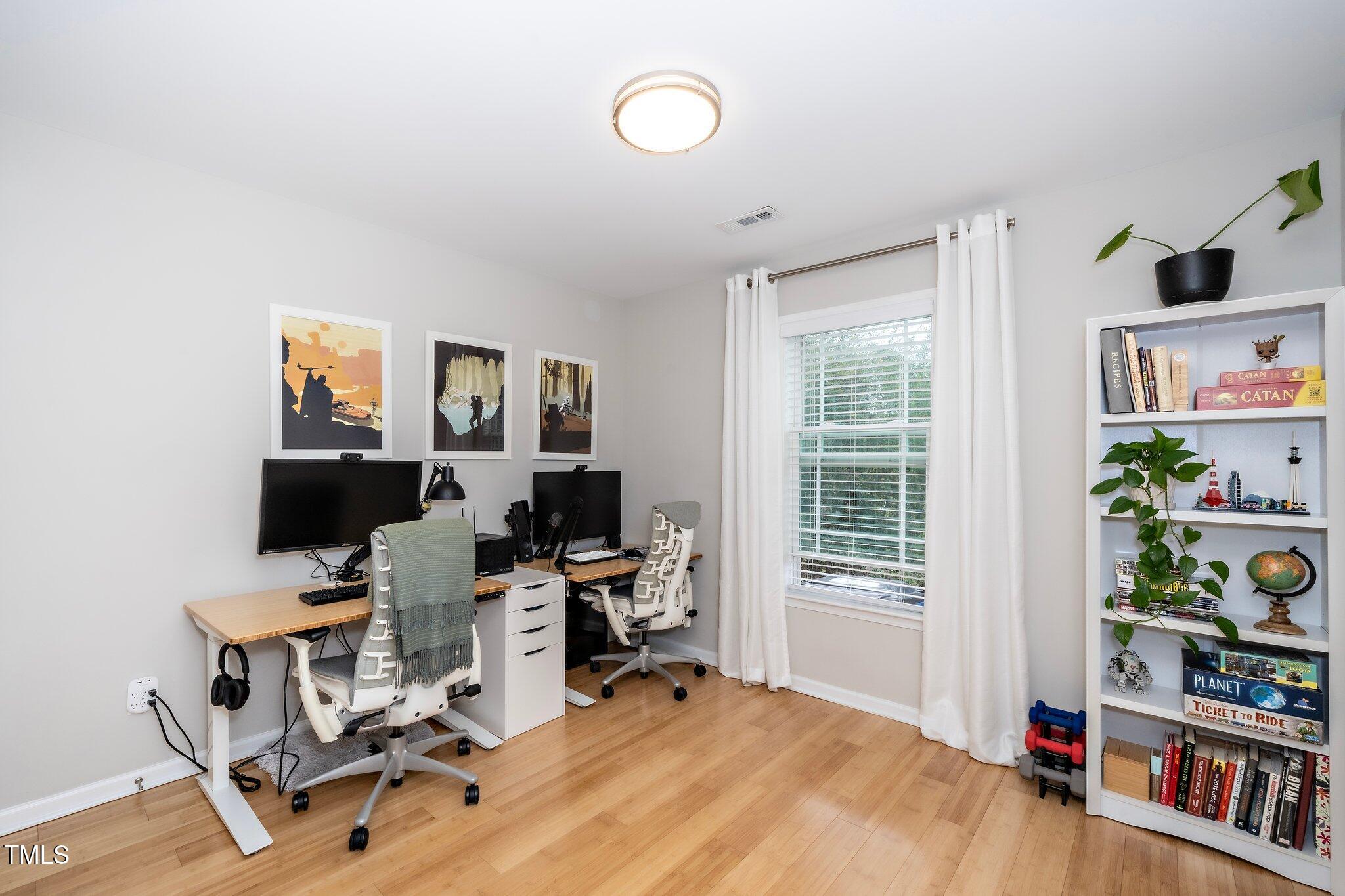 1320 South State Street, Unit D Raleigh, NC 27610 - Photo 4 of 18 a view of a workspace with furniture and a window