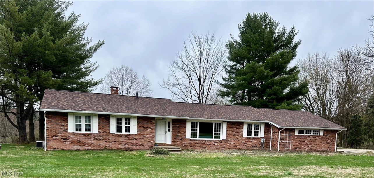7583 Hartman Road Wadsworth, OH 44281 - Photo 1 of 30 Ranch-style house featuring a chimney, brick siding, and a front yard