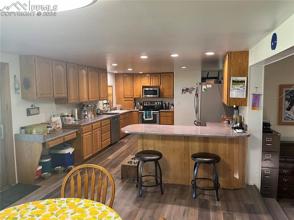 5576 County Rd G Joes, CO 80822 - Photo 2 of 30 a large kitchen with a table and chairs in it