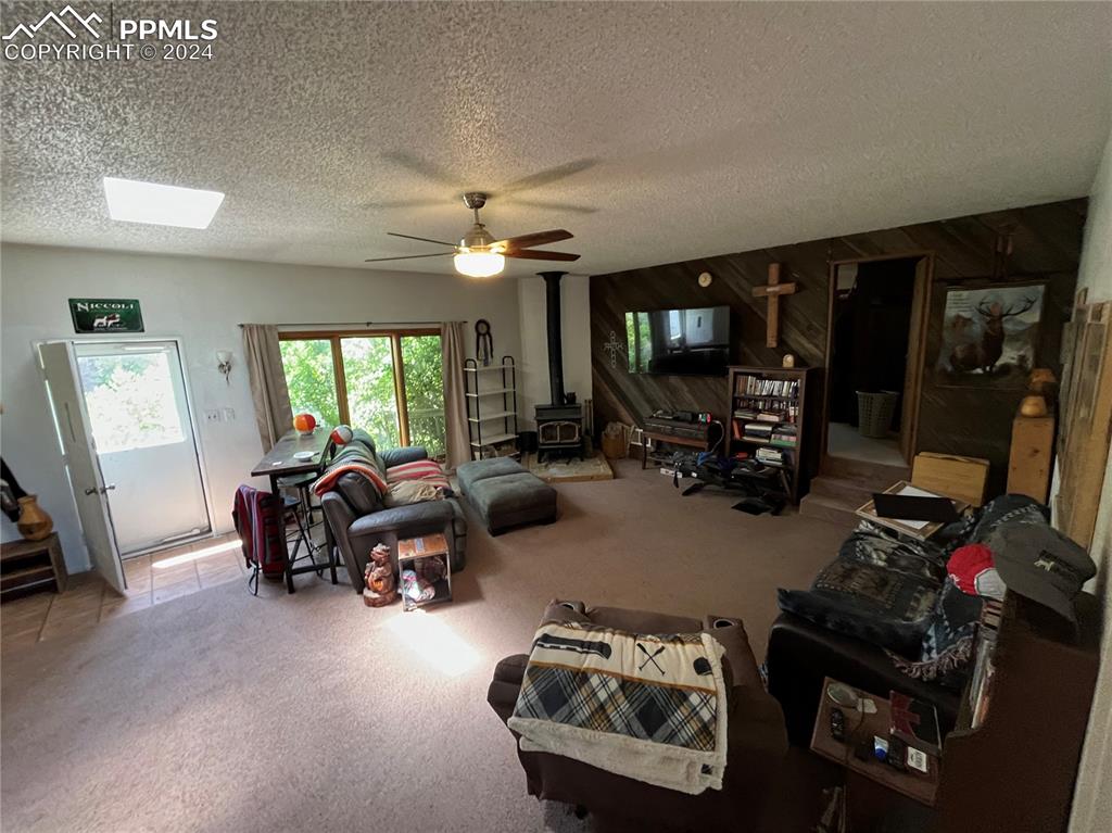 5576 County Rd G Joes, CO 80822 - Photo 10 of 30 a living room with furniture a large window and gym equipment