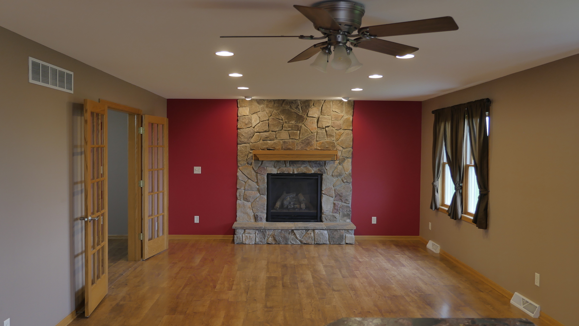 874 North 36th Road Utica, IL 61373 - Photo 2 of 14 a view of a livingroom with a fireplace a ceiling fan and window
