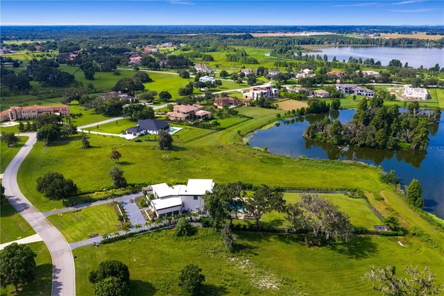 an aerial view of a houses with a swimming pool