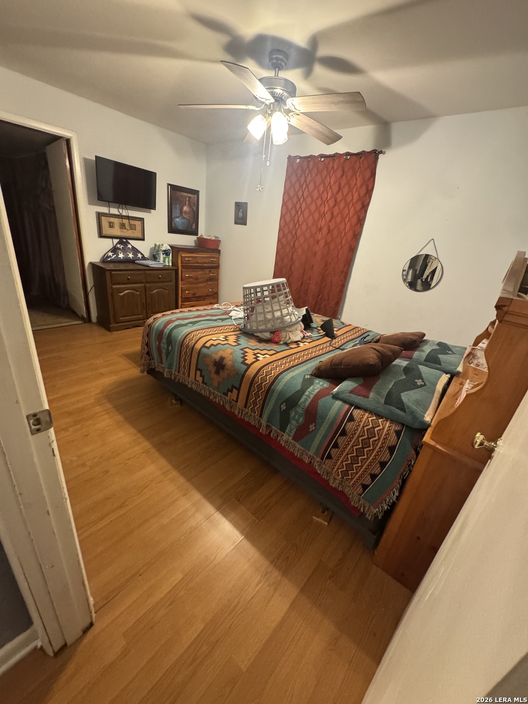 504 North Cedar Street Pearsall, TX 78061 - Photo 11 of 23 a bedroom with a bed and a television