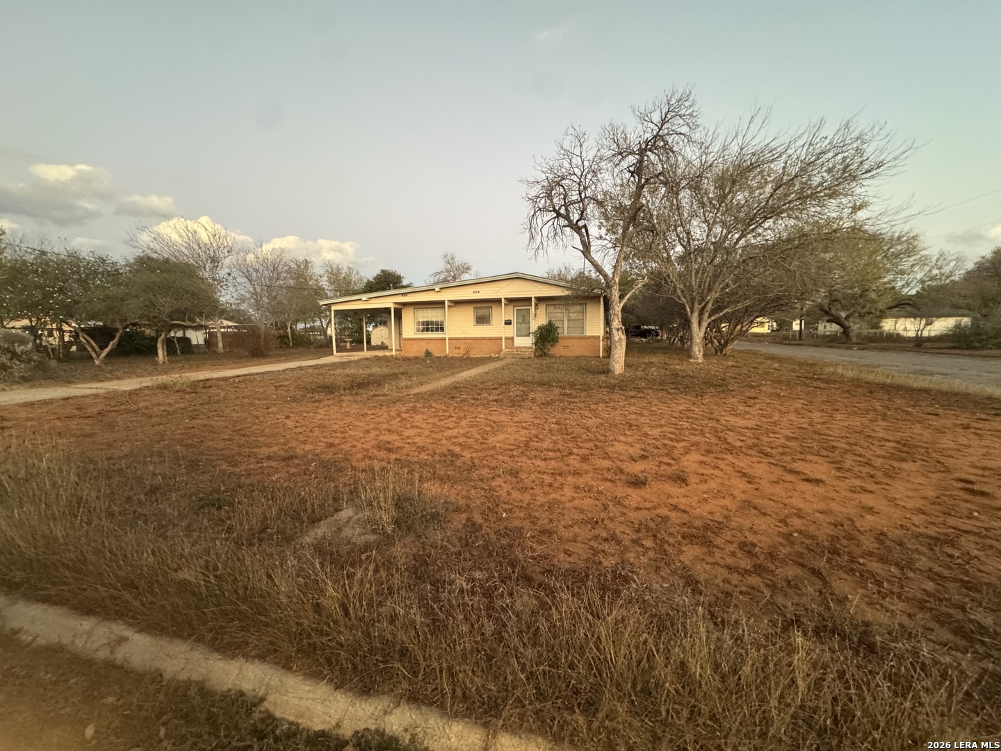 504 North Cedar Street Pearsall, TX 78061 - Photo 2 of 23 a front view of house with yard and trees