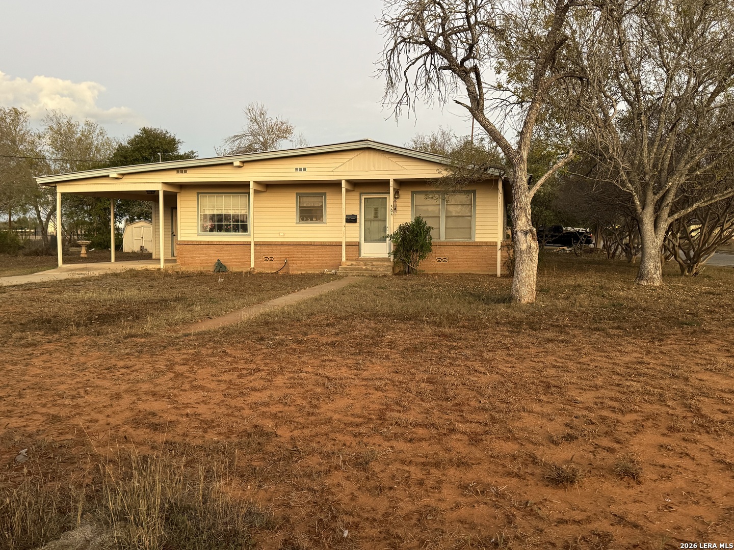 504 North Cedar Street Pearsall, TX 78061 - Photo 3 of 23 a front view of a house with a yard