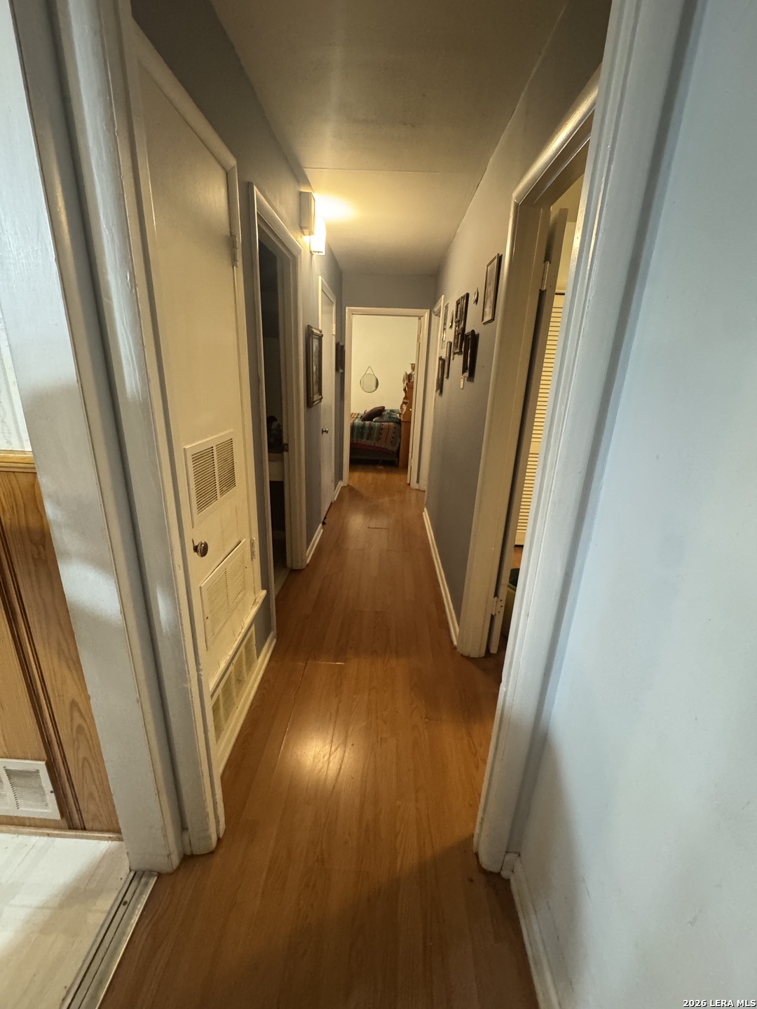 504 North Cedar Street Pearsall, TX 78061 - Photo 7 of 23 a view of a hallway with wooden floor and stairs