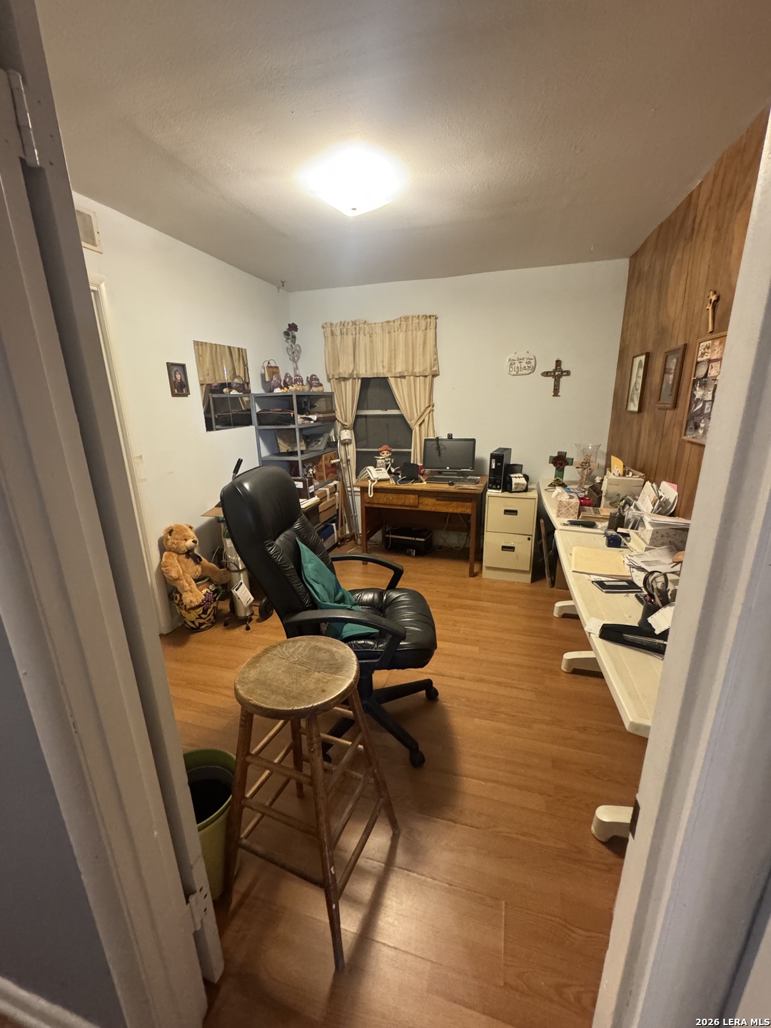 504 North Cedar Street Pearsall, TX 78061 - Photo 8 of 23 a room with furniture and a wooden floor