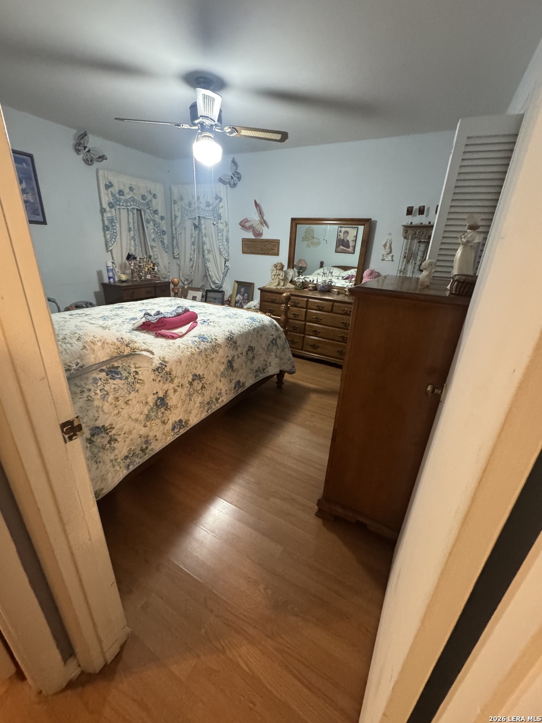 504 North Cedar Street Pearsall, TX 78061 - Photo 10 of 23 a bedroom with a bed and a large mirror on the wall