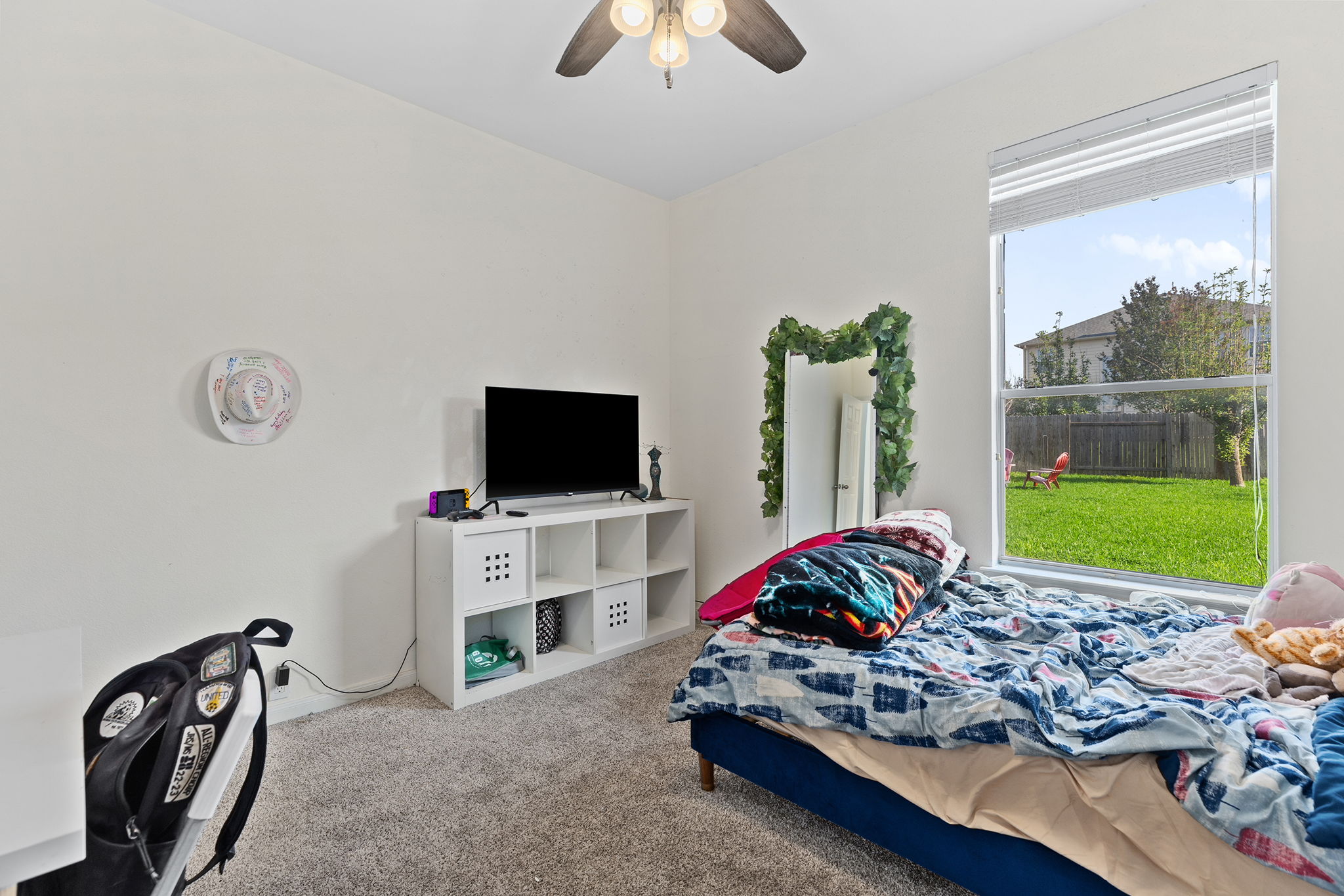 3517 Shiraz Loop Round Rock, TX 78665 - Photo 23 of 40 Carpeted room featuring a large window with horizontal blinds, a ceiling fan with integrated lighting, and neutral wall tones