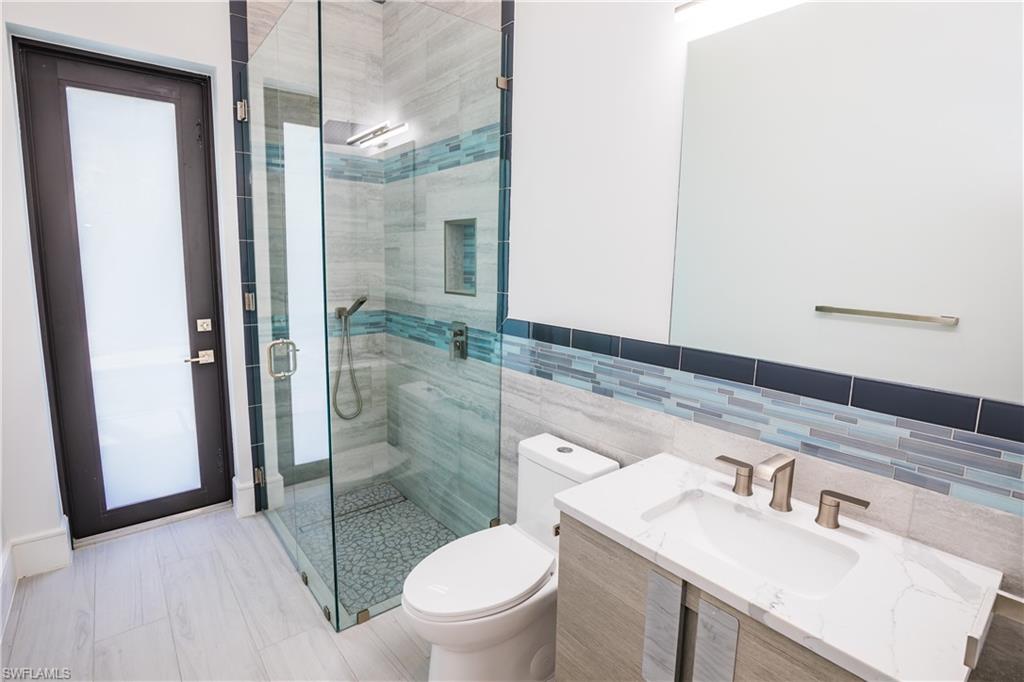 231 Legacy Court Naples, FL 34110 - Photo 16 of 35 a bathroom with a sink toilet and shower