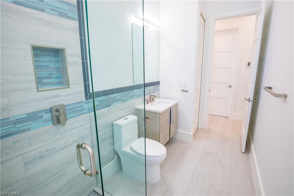 231 Legacy Court Naples, FL 34110 - Photo 17 of 35 a bathroom with a sink a toilet and shower