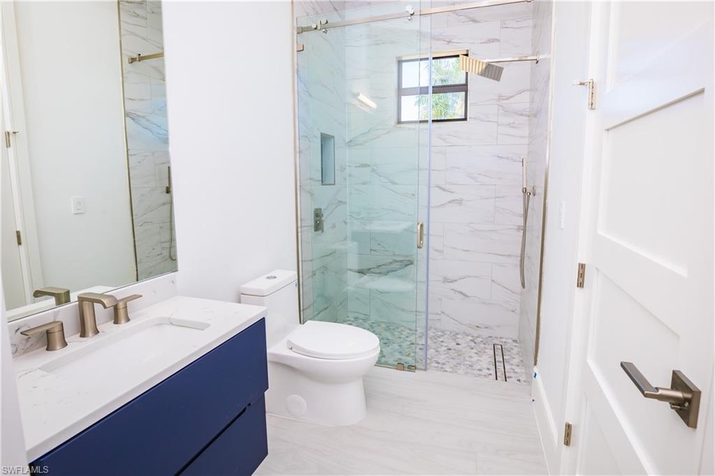 231 Legacy Court Naples, FL 34110 - Photo 20 of 35 a bathroom with a sink and a mirror