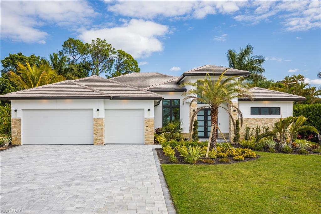 231 Legacy Court Naples, FL 34110 - Photo 2 of 35 a front view of a house with a yard