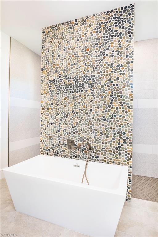 231 Legacy Court Naples, FL 34110 - Photo 27 of 35 a bathroom with a bathtub and shower