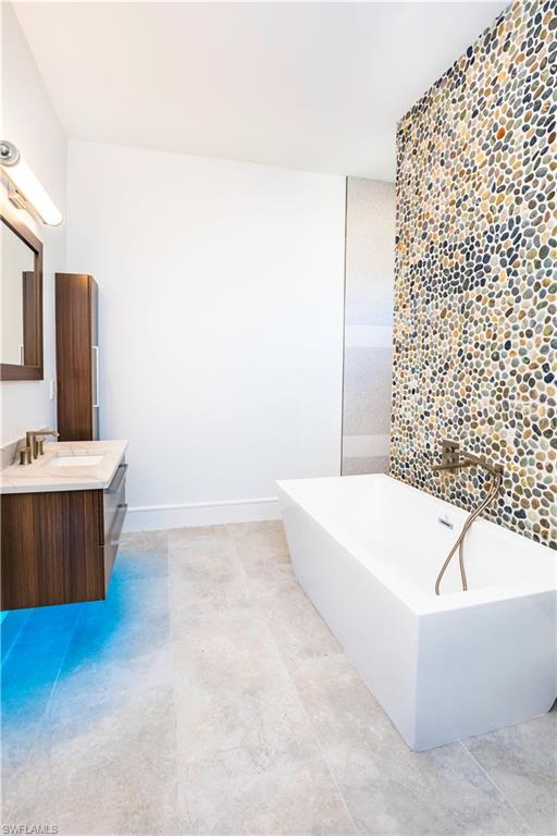 231 Legacy Court Naples, FL 34110 - Photo 28 of 35 a bathroom with a bathtub and a sink