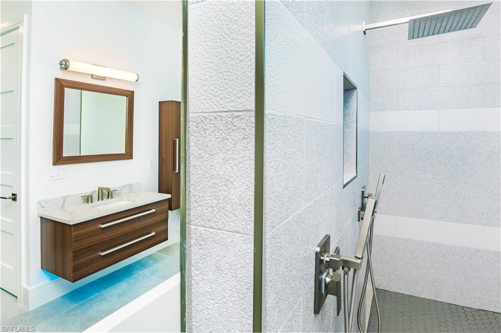 231 Legacy Court Naples, FL 34110 - Photo 30 of 35 a bathroom with a sink and a mirror