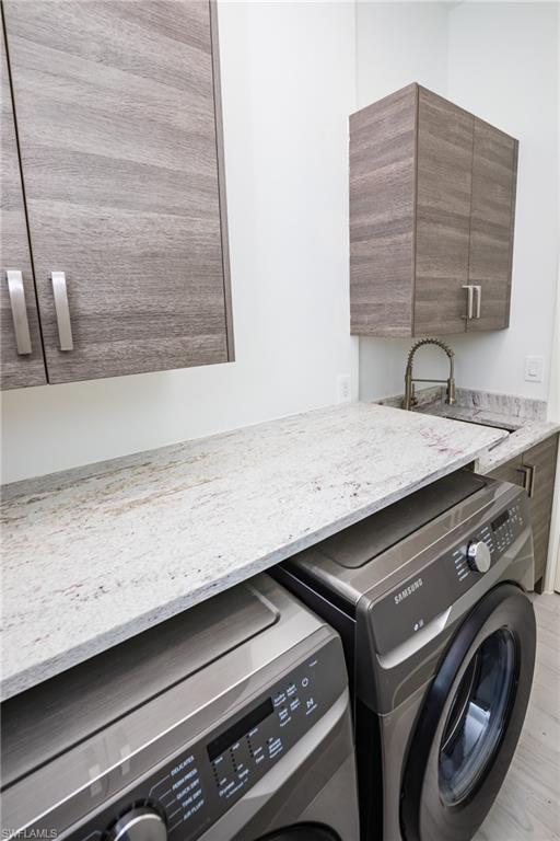231 Legacy Court Naples, FL 34110 - Photo 34 of 35 a utility room with washer and dryer