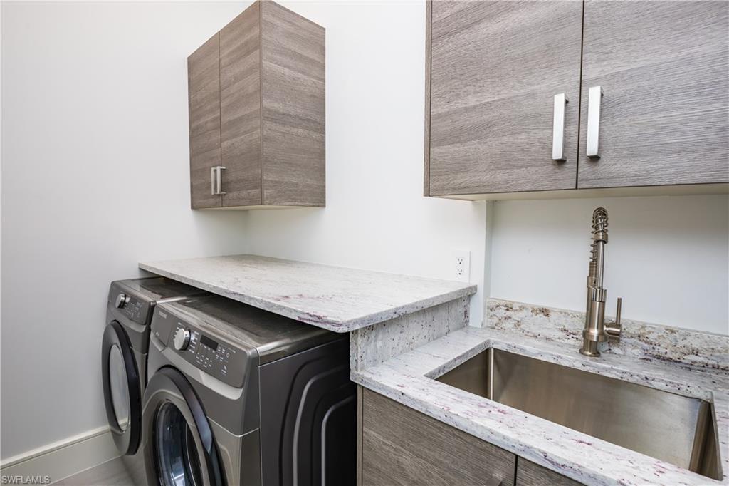 231 Legacy Court Naples, FL 34110 - Photo 35 of 35 a utility room with dryer and washer