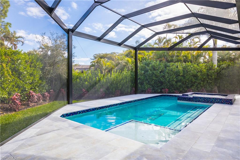 231 Legacy Court Naples, FL 34110 - Photo 4 of 35 a view of a swimming pool with a yard