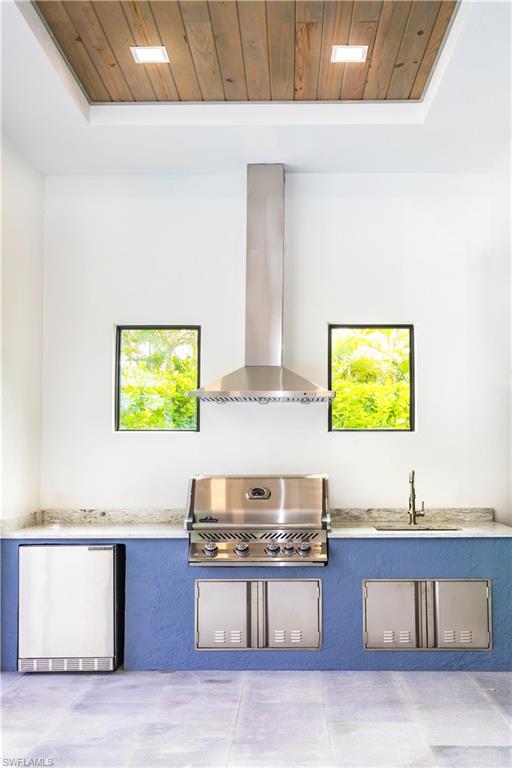 231 Legacy Court Naples, FL 34110 - Photo 7 of 35 a kitchen with stainless steel appliances granite countertop a sink and a stove top oven