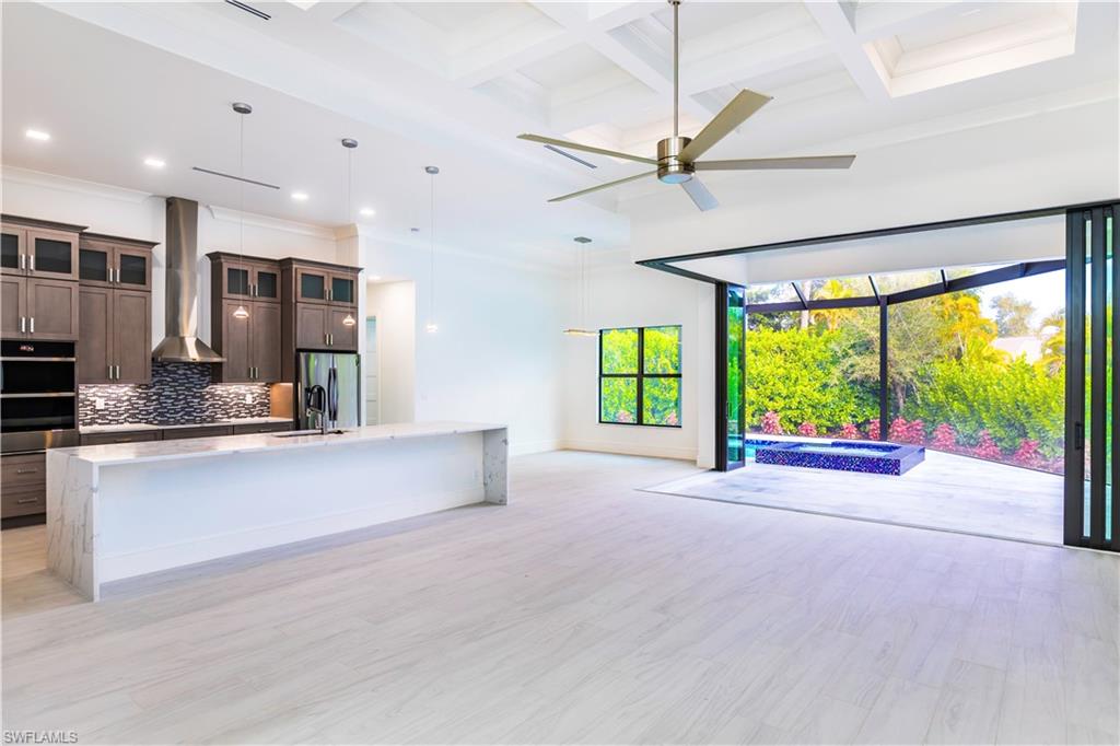 231 Legacy Court Naples, FL 34110 - Photo 8 of 35 a large kitchen with stainless steel appliances a large window