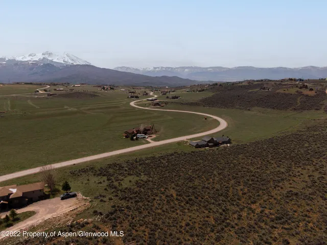 an aerial view of a house with a lake view