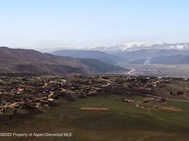 a view of a dry yard with mountain view