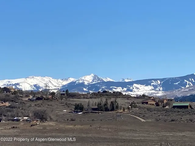 a view of a town with mountains in the background