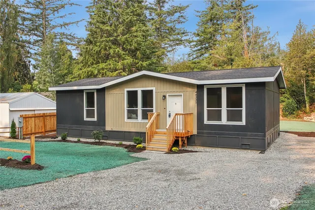 a view of a house with backyard and sitting area