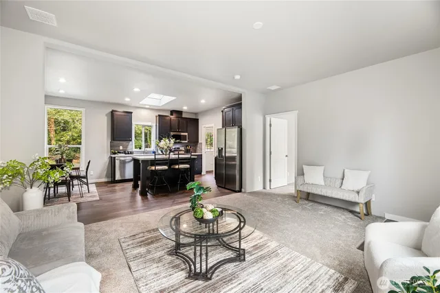 a living room with furniture and kitchen view