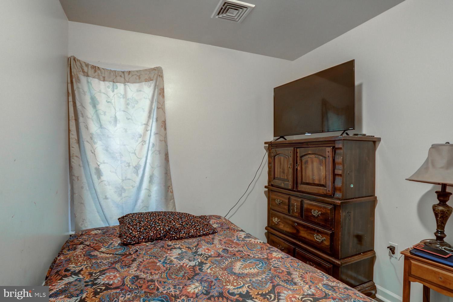 417 Green Street Lancaster, PA 17602 - Photo 31 of 37 a bedroom with a bed and flat screen tv