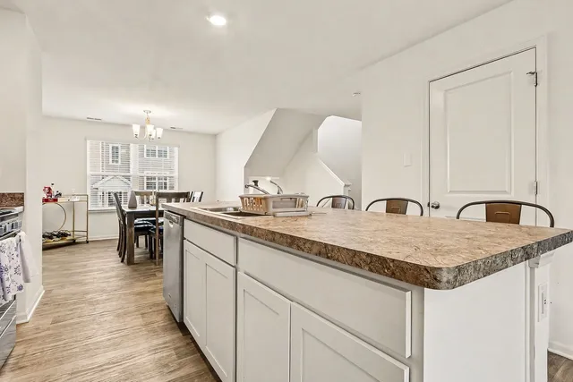 a kitchen with stainless steel appliances granite countertop a sink stove and cabinets