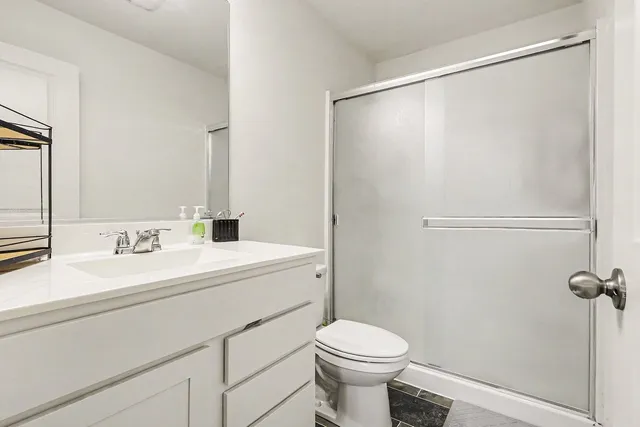 a bathroom with a sink a toilet and a mirror