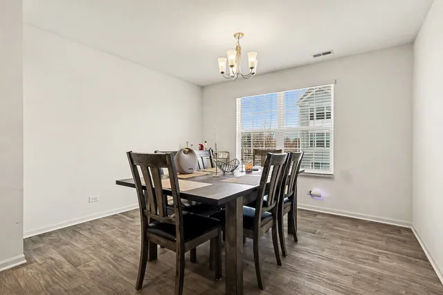 a view of a dining room with furniture and window