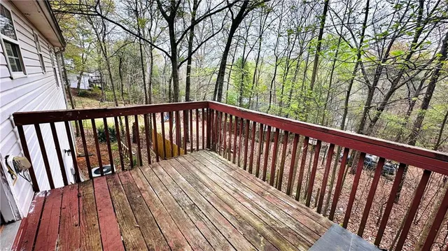 a view of balcony with wooden floor and fence