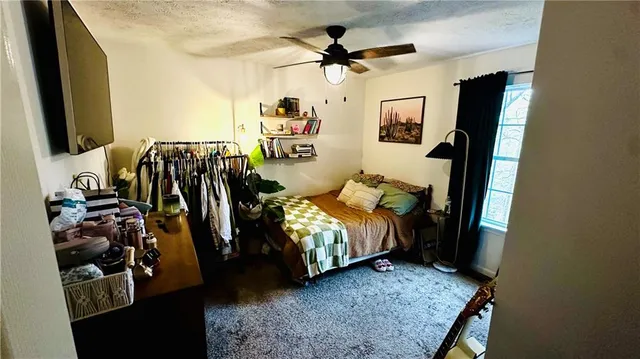 a living room with bed furniture and a flat screen tv