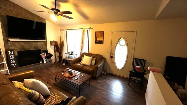 a living room with furniture fireplace and flat screen tv