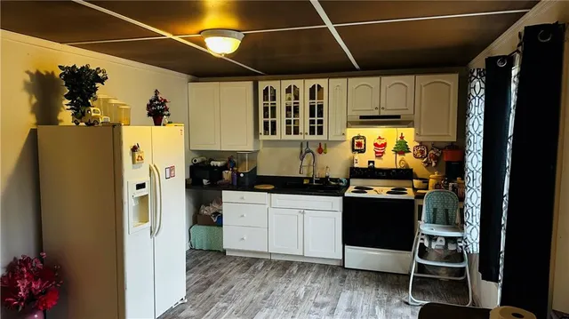 a kitchen with stainless steel appliances a stove a refrigerator and cabinets
