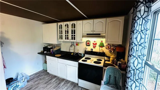 a kitchen with stainless steel appliances a sink a stove a refrigerator and cabinets