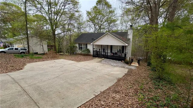 a view of a house with a yard and tree s