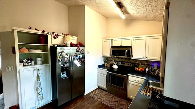 a kitchen with stainless steel appliances a stove and a refrigerator