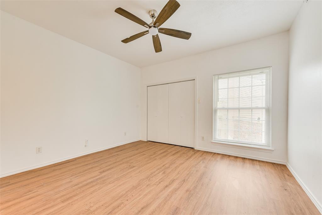 14277 Preston Road, Unit 823 Dallas, TX 75254 - Photo 13 of 25 an empty room with wooden floor fan and windows