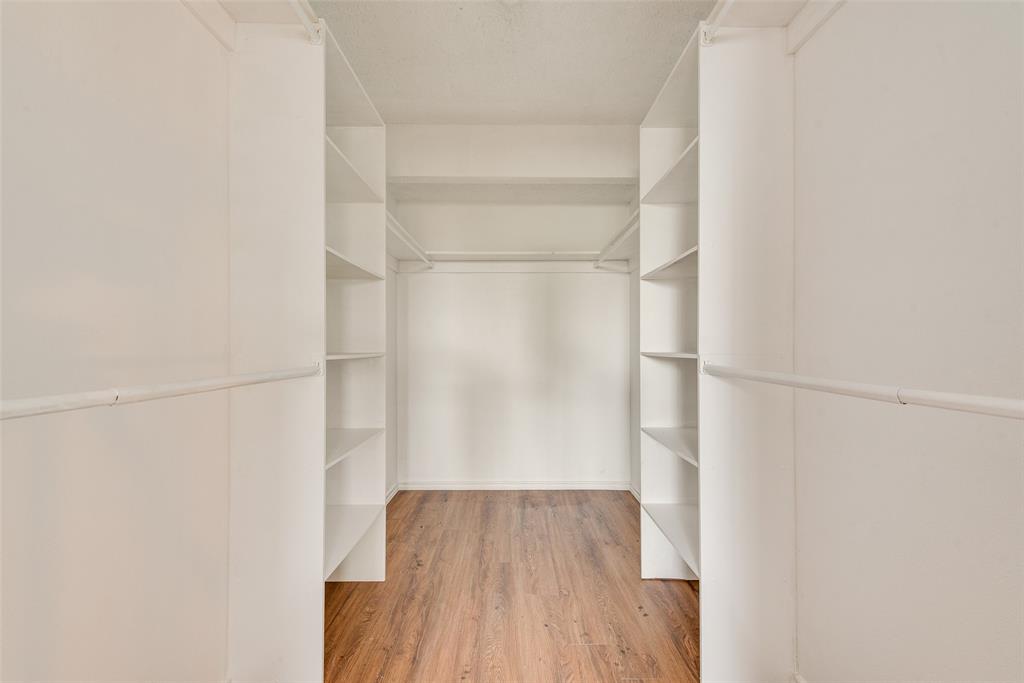 14277 Preston Road, Unit 823 Dallas, TX 75254 - Photo 17 of 25 a view of walk in closet with wooden floor