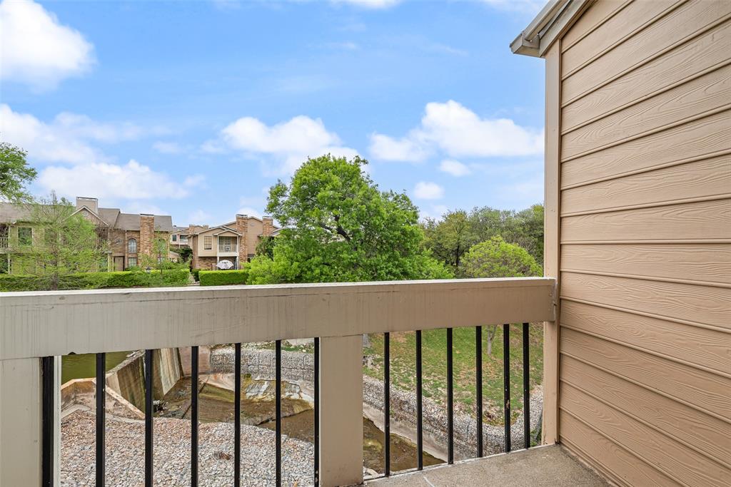14277 Preston Road, Unit 823 Dallas, TX 75254 - Photo 19 of 25 a view of a balcony with wooden fence