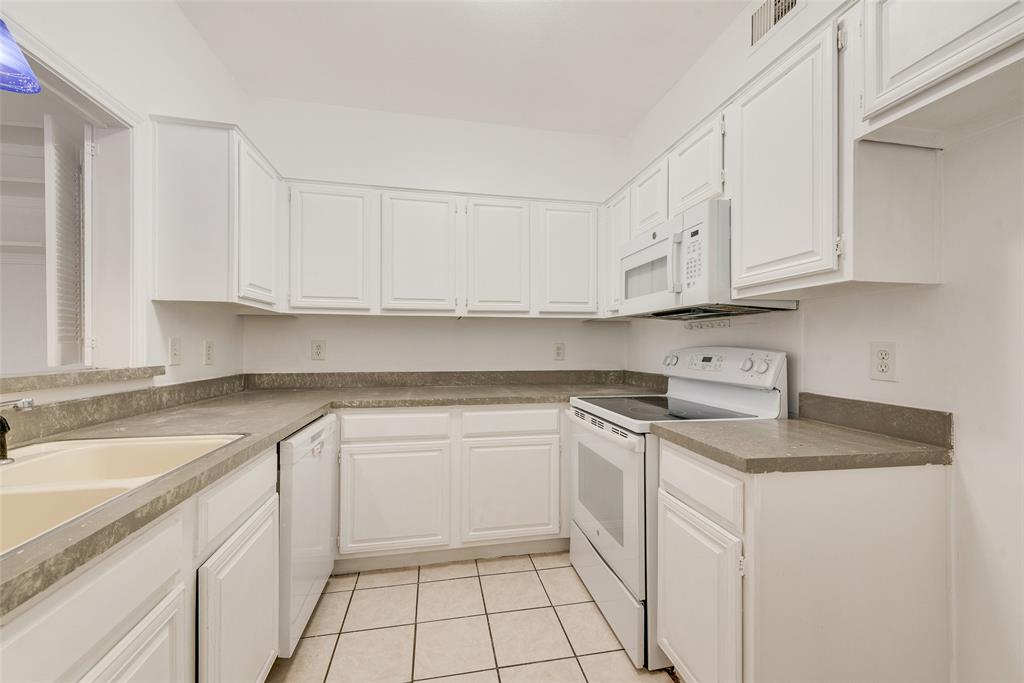 14277 Preston Road, Unit 823 Dallas, TX 75254 - Photo 5 of 25 a kitchen with stainless steel appliances granite countertop a sink stove and cabinets