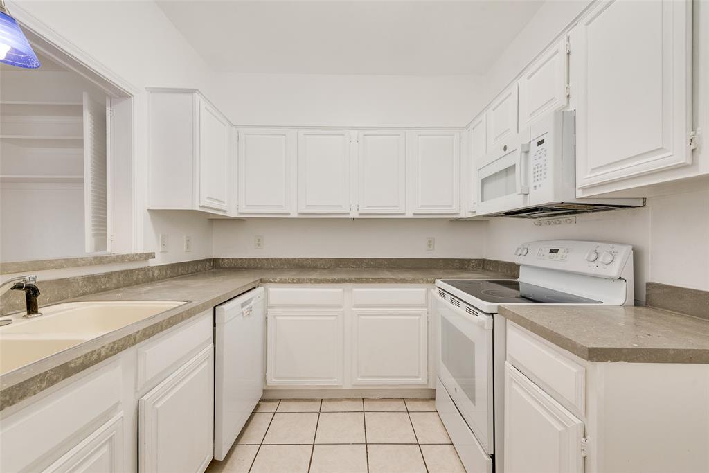 14277 Preston Road, Unit 823 Dallas, TX 75254 - Photo 6 of 25 a kitchen with white cabinets and a sink