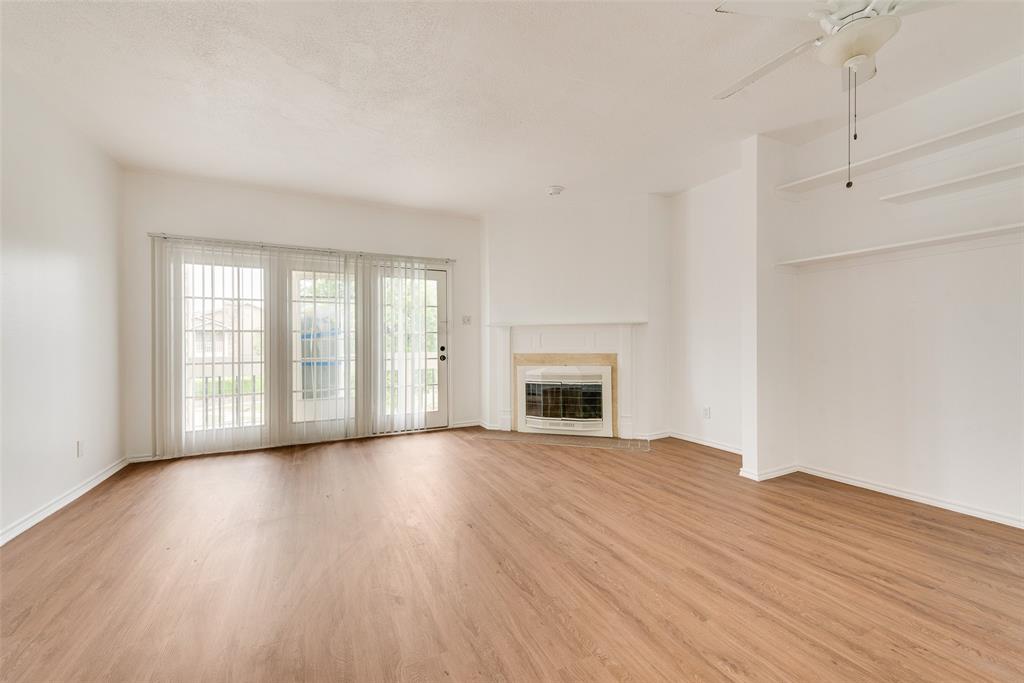 14277 Preston Road, Unit 823 Dallas, TX 75254 - Photo 8 of 25 a view of an empty room with wooden floor and a window