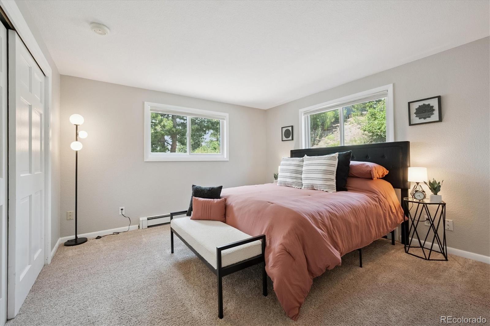 9189 Fallen Rock Road Conifer, CO 80433 - Photo 14 of 47 a bedroom with a bed and window